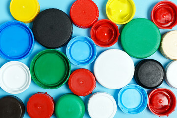  Multi-colored plastic bottle caps background. The problem of environmental pollution. Top view, flat lay. Recycling plastic.