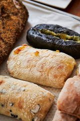Various crusty bread on wooden background
