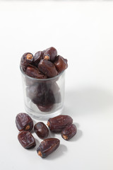 Dried dates fruits on white background, tasted sweet and chewy