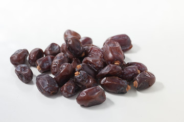 Dried dates fruits on white background, tasted sweet and chewy