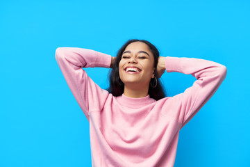 Happy laughing black woman on blue background