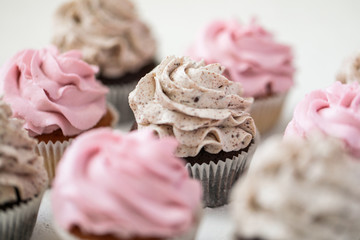 cupcakes with pink and chocolate chips on a white plate, homemade muffins
