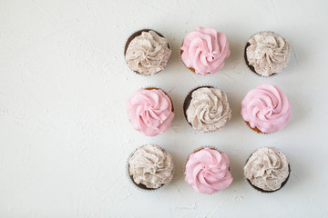 Cupcakes with pink and chocolate chips on a white background, top view, plenty of free space for text or description. homemade muffins
