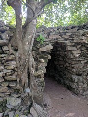 Stone maya entry on a wall in tulum, mexico