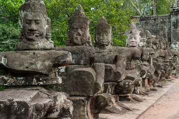 Fototapeta na wymiar Statues on the Bridge Leading to the Victory Gate in the Ancient City of Angkor Thom, Cambodia