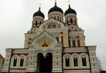 Fototapeta na wymiar The ancient Christian church of Alexander Nevsky. The building of the church with several domes in Tallinn.
