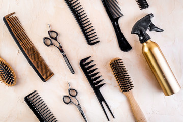 Hairdresser tools. Flat lay on beige background top view