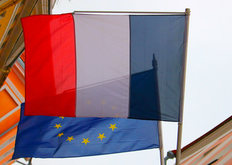The flag of France hangs next to the flag of the European Union.