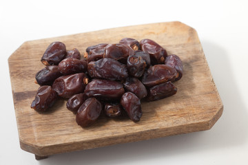 Dried dates fruits on white background, tasted sweet and chewy