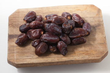 Dried dates fruits on white background, tasted sweet and chewy