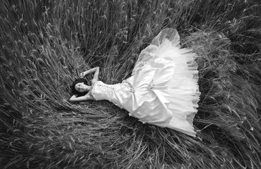 bride laying in grain field