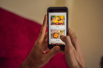 man orders food for lunch online using smartphone