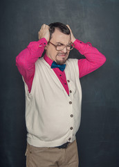 Tired funny teacher on businessman in eyeglasses on blackboard