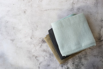 Stack kitchen cotton towels on gray background