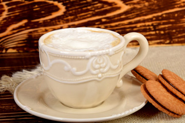 coffee with white milk froth and cookies