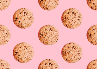 Oatmeal cookies with chocolate chips Seamless pattern with oat biscuits on pink background