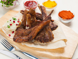 lamb loin on pita bread with onion and pomegranate seeds