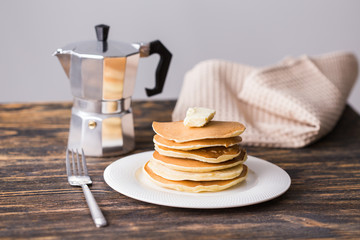 Pile of tasty pancakes with butter. Breakfast concept.