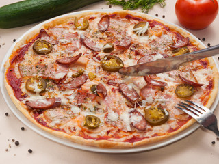 spicy pizza with sausage meat and jalapeno