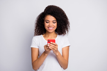 Close-up portrait of her she nice attractive cheerful cheery focused wavy-haired girl using cell device gadget isolated over light white pastel color background