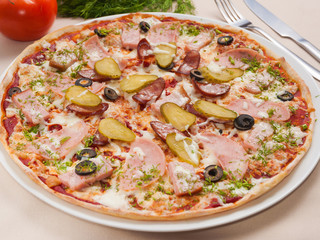 pizza with meat sausage, pickles and olives