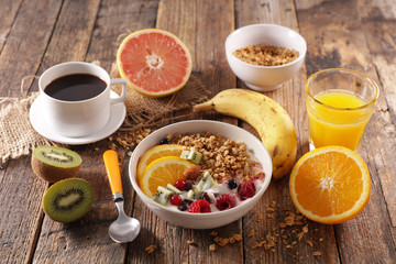 breakfast with cereal, fruit, orange juice and coffee cup