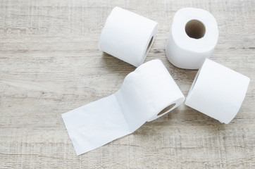 white toilet paper roll on wood background.