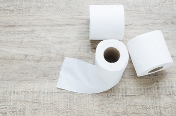 white toilet paper roll on wood background.
