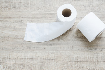 white toilet paper roll on wood background.