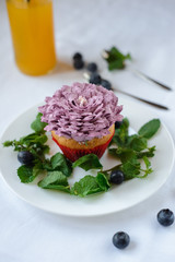 Delicious cupcake on a white plate on a white background.