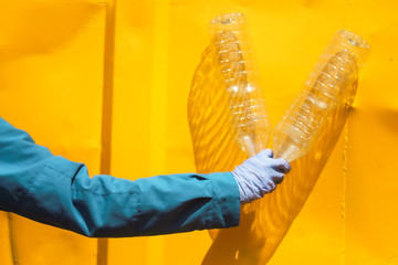 Imagen conceptual de la acción de reciclar plástico con guantes protectores sanitarios para...