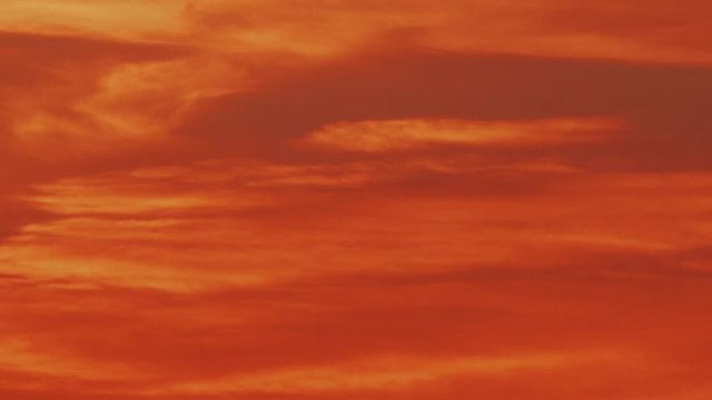 Time-lapse video of slowly floating peculiar orange and red clouds