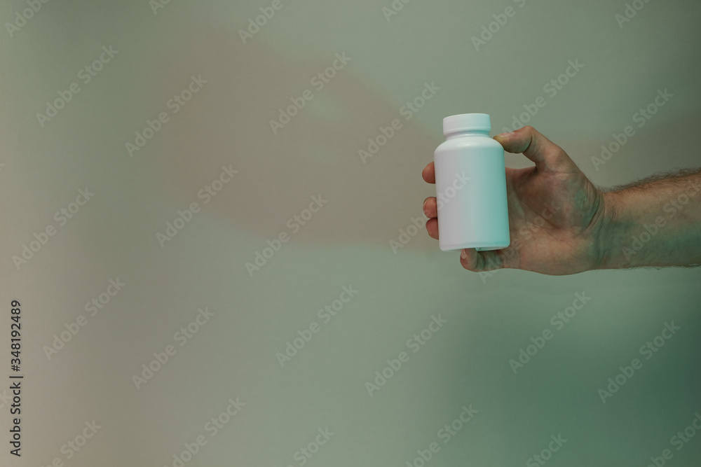 Poster hand hold white bottle for pills in the color light. beautiful old minimal in neon light. minimalism