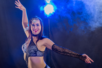 Young woman dancing in Tribal Fusion style. Belly dance on the stage.