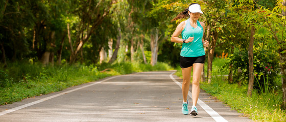 Asian wonman  in sport wear jogging  on raod at park