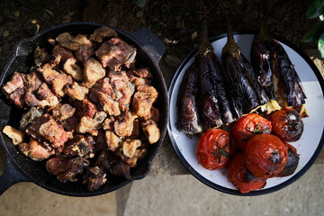 Barbecue grilled vegetables and meat, close-up. Baked tomatoes, aubergine