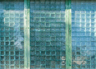 Pattern of green glass blocks. Industrial background. Glass block wall. Textured glass bricks in...
