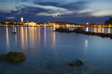 Fototapeta na wymiar Picturesque coastal view of Rab town waterfront at night. Rab island, Croatia