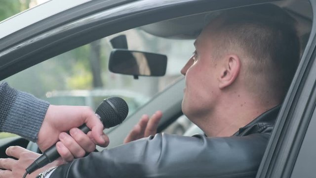 Unhappy and aggressive driver gives interview to journalist, closeup