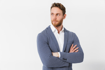 Image of unshaven young man posing on camera with hands crossed
