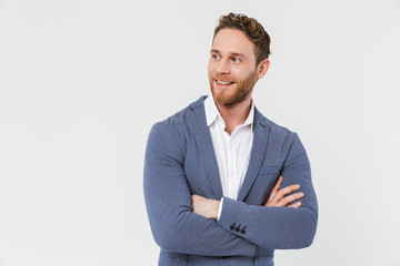 Image of smiling young man posing on camera with hands crossed