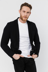 Image of unshaven confident man in jacket posing and looking at camera