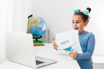 little girl learning history on laptop online