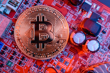 Mining bitcoin; a bitcoin and electronic board.