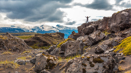 A young woman on top of a mound on the 4-day trek from Landmannalaugar. Iceland