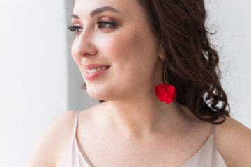 Close-up portrait of beautiful young woman with elegant hairstyle and luxurious jewelry and bijouterie.