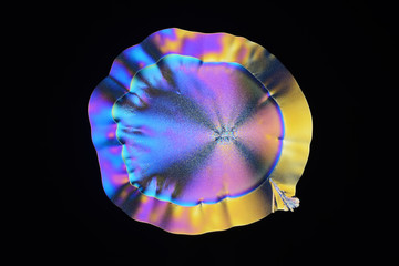 Colorful micro crystals in polarized light. Photo through a microscope.