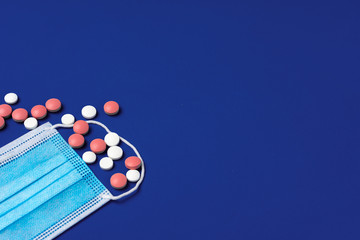 Vitamins and face protective mask close up. Coronavirus prevention concept