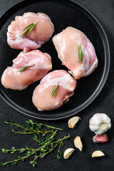 Raw chicken drumstick fillet without skin. Farm poultry meat. Black background. Top view