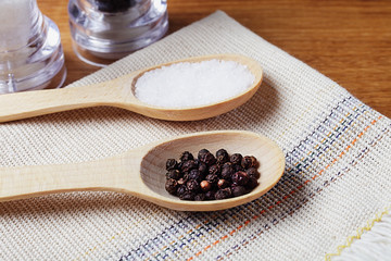 wooden spoons with sea salt and pepper on a linen napkin